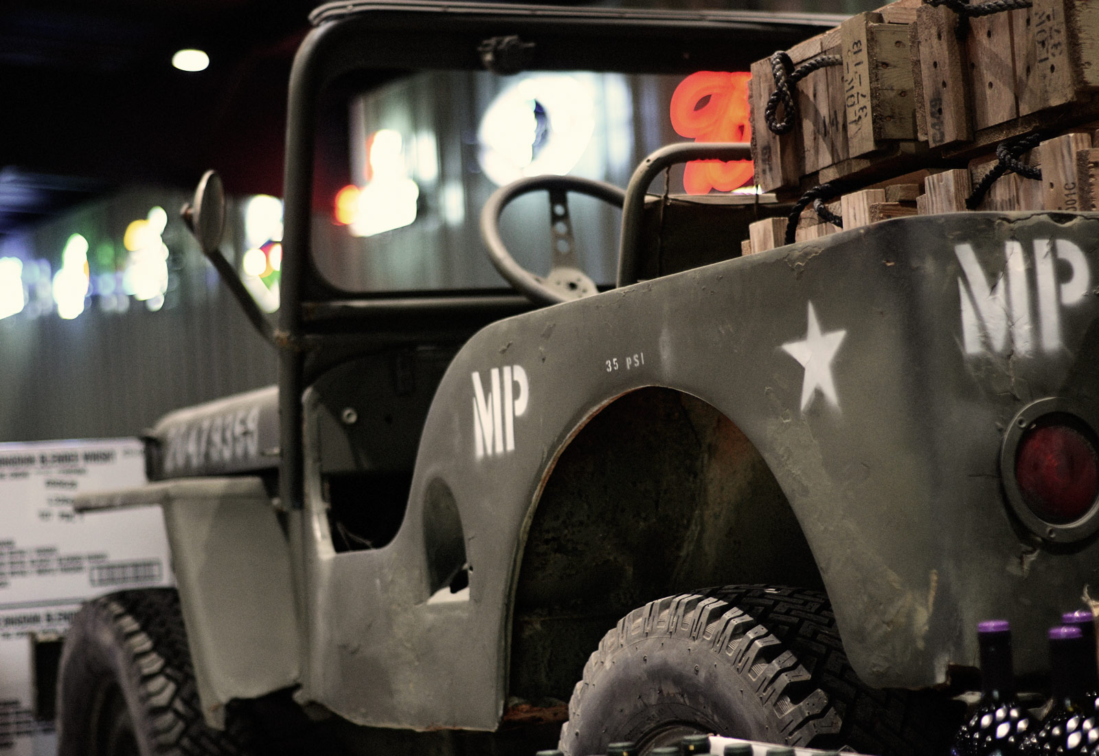 WW2 army jeep in Luckys Liquors store emphasizing retail interior design