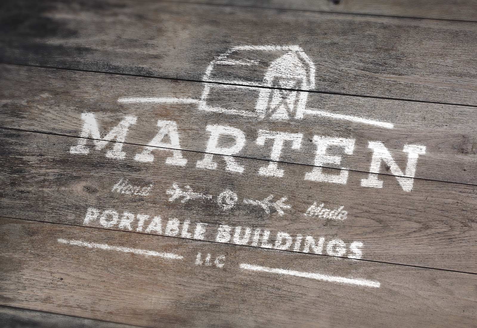 Marten Portable Buildings logo painted on wood showing shed company branding