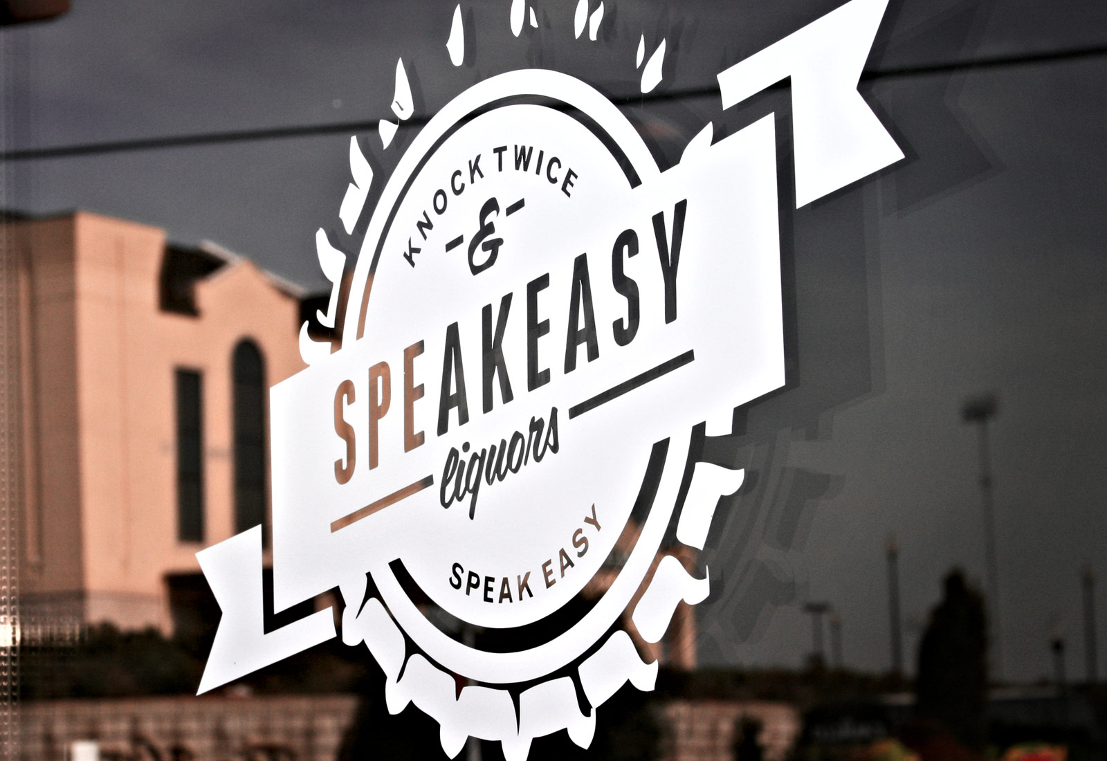 Speakeasy Liquors logo on window vinyl showcasing retail branding
