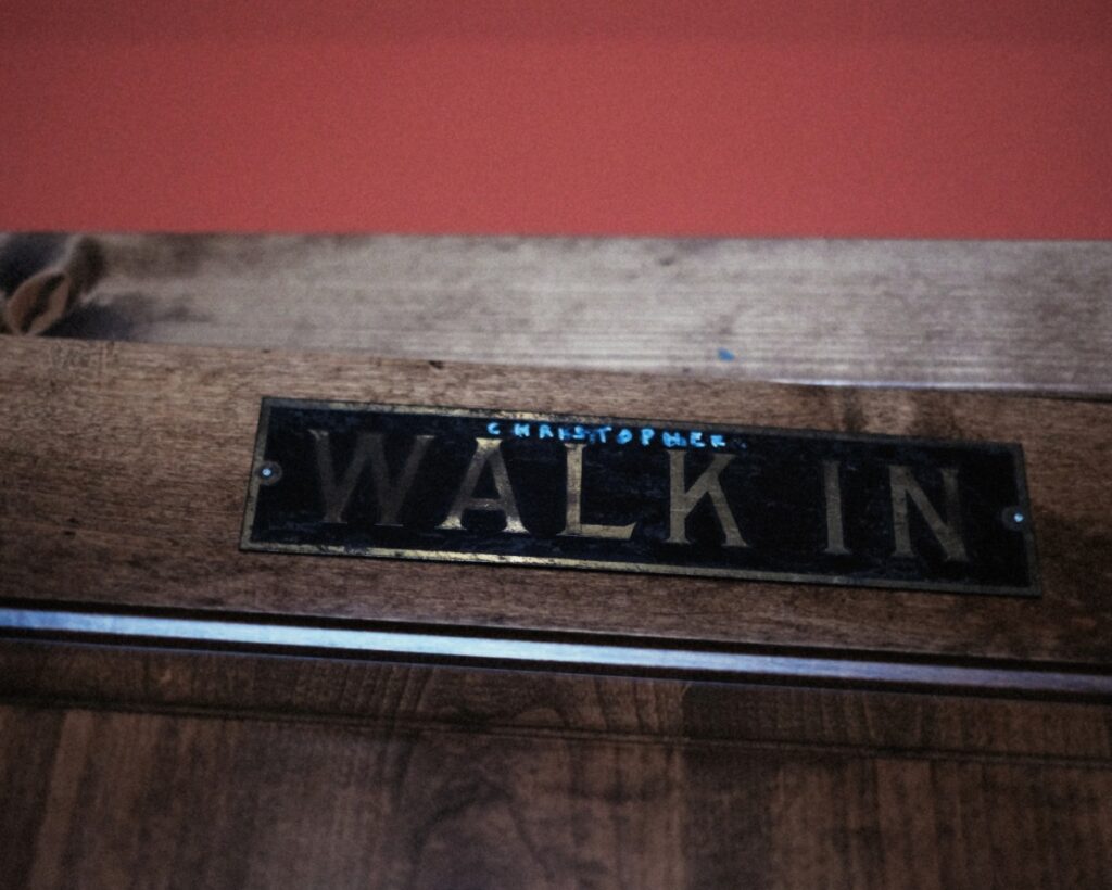 A cheeky nod to actor Christopher Walken on a "Walk In" sign with "Christopher" written in above it with marker